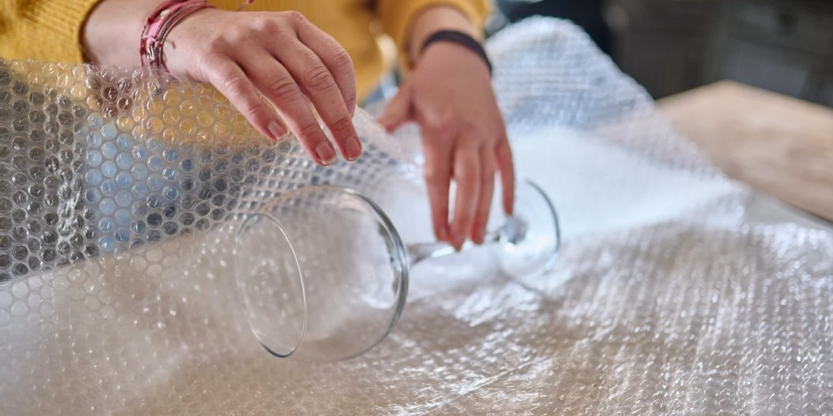 Wrapping fragile glass items with bubble wrap