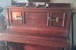 Upright piano, with candle holders on the front