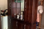 Bar counter with display case and 5 chairs