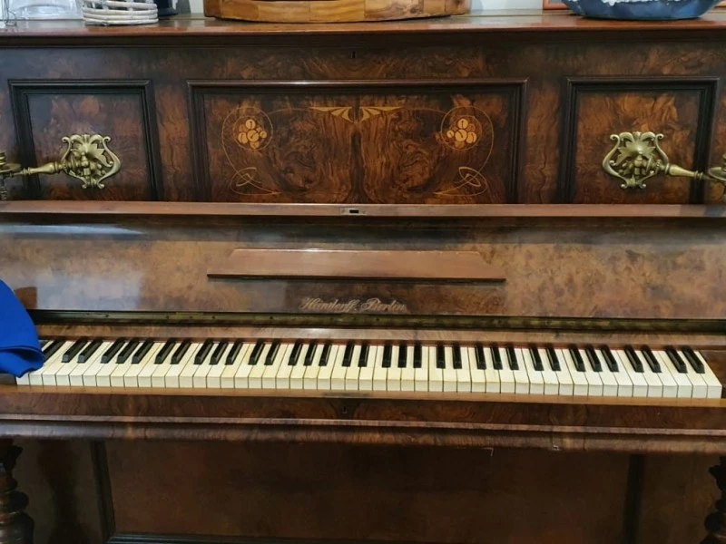 Old classic oak covered stand up piano