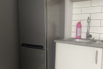 Double bed, fridge, microwave, small 2 seat table