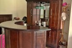 Bar counter with display case and 5 chairs