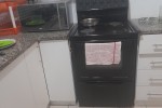 2 beds, fridge, couches, washing machine, TV, clothes, stove