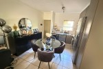 Bed and side tables, Round glass dinner table, couch, living room side...
