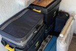 3 large plastic boxes, 2 medium suitcases, 2 tool boxes, 1 model ship ...