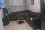 2 beds, fridge, couches, washing machine, TV, clothes, stove