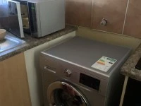Corner sofa, table and 4 chairs, fridge, washing machine, 2 single bed...