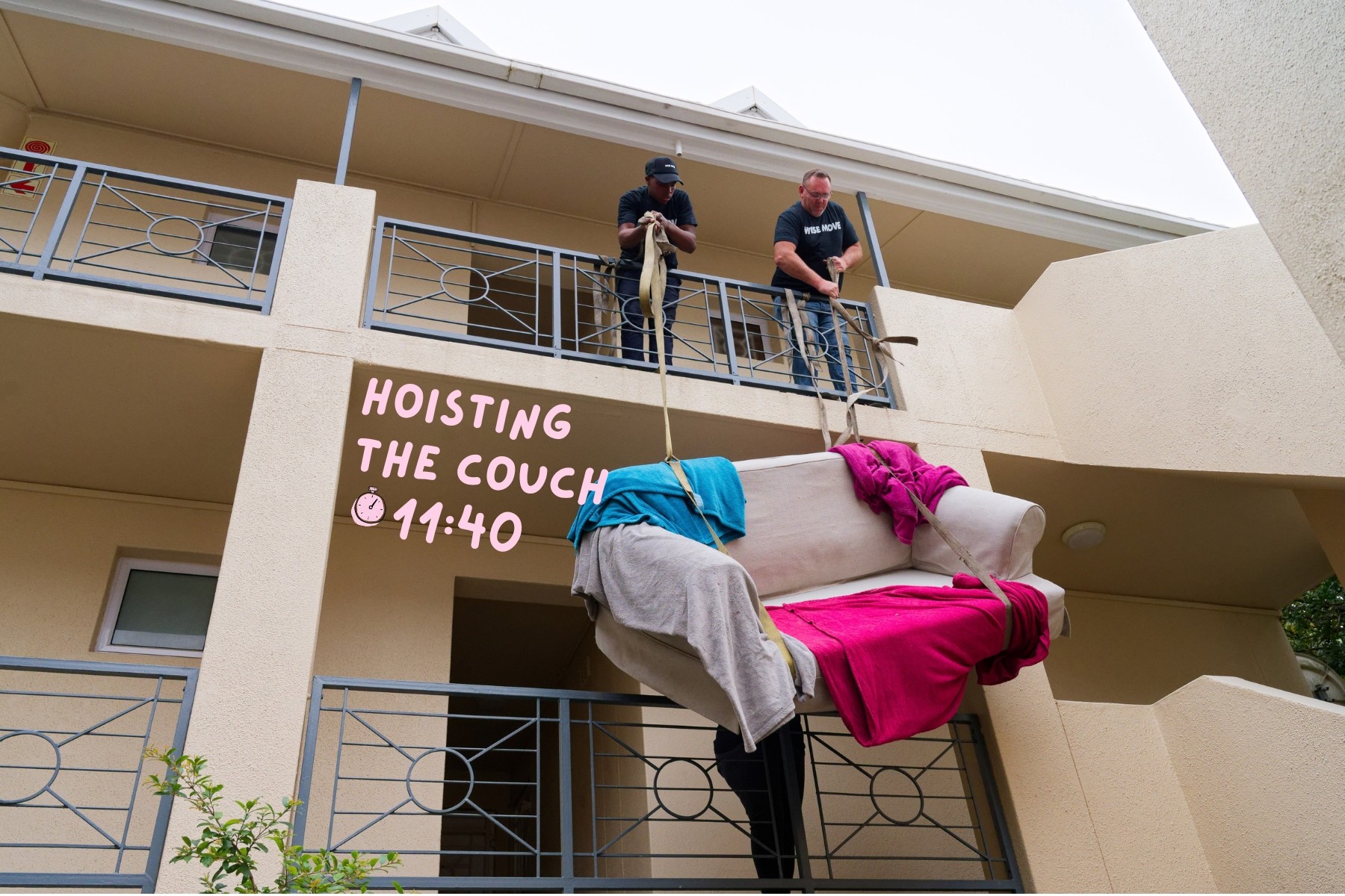 Wise Move movers easily hoisting a couch up two floors