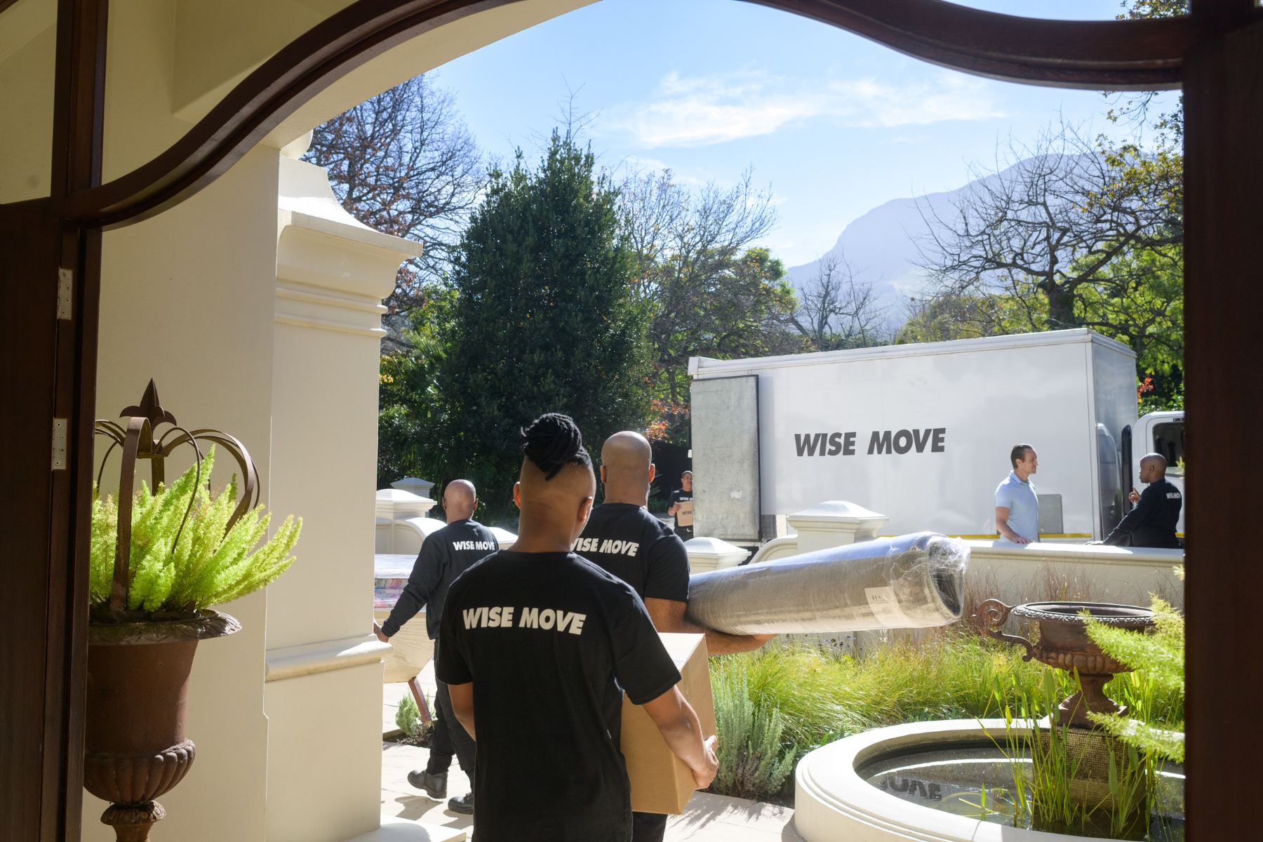 Moving team carrying family belongings to a moving truck