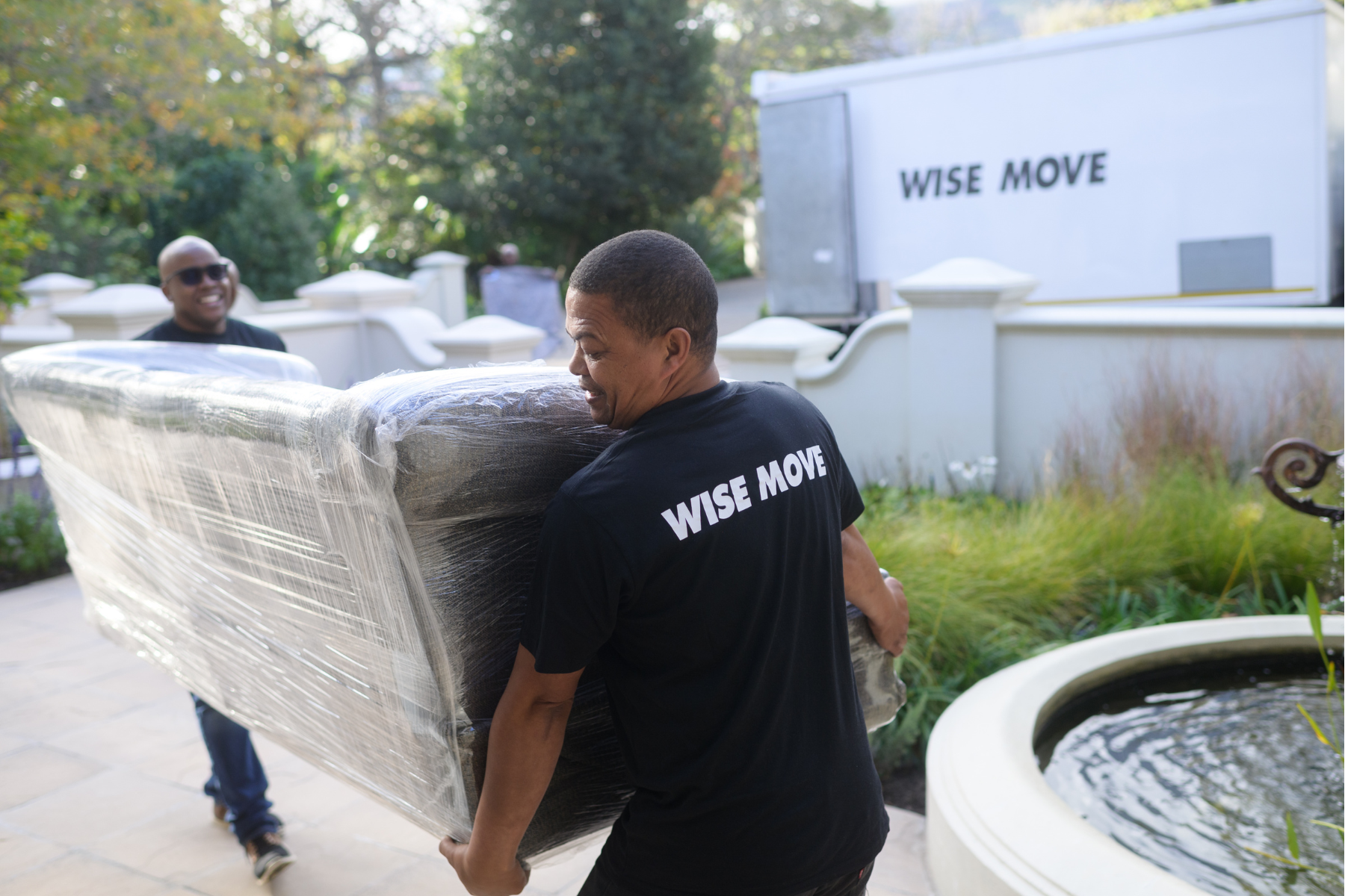 Wise Move moving team loading a couch onto a moving truck