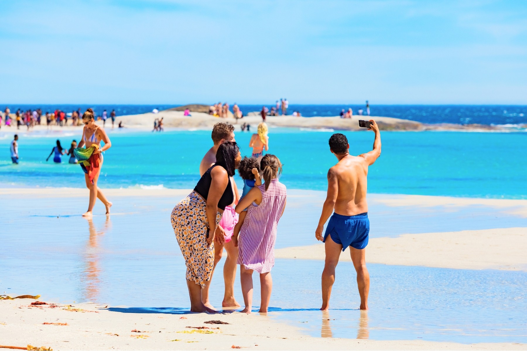 Family making the most of their beach trip in Cape Town during December