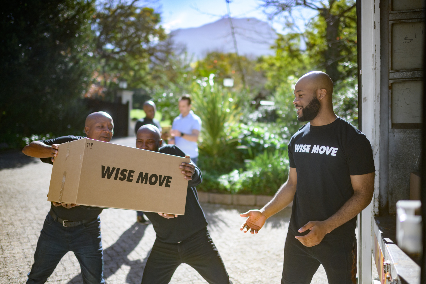Professional moving team loading a moving truck with moving boxes