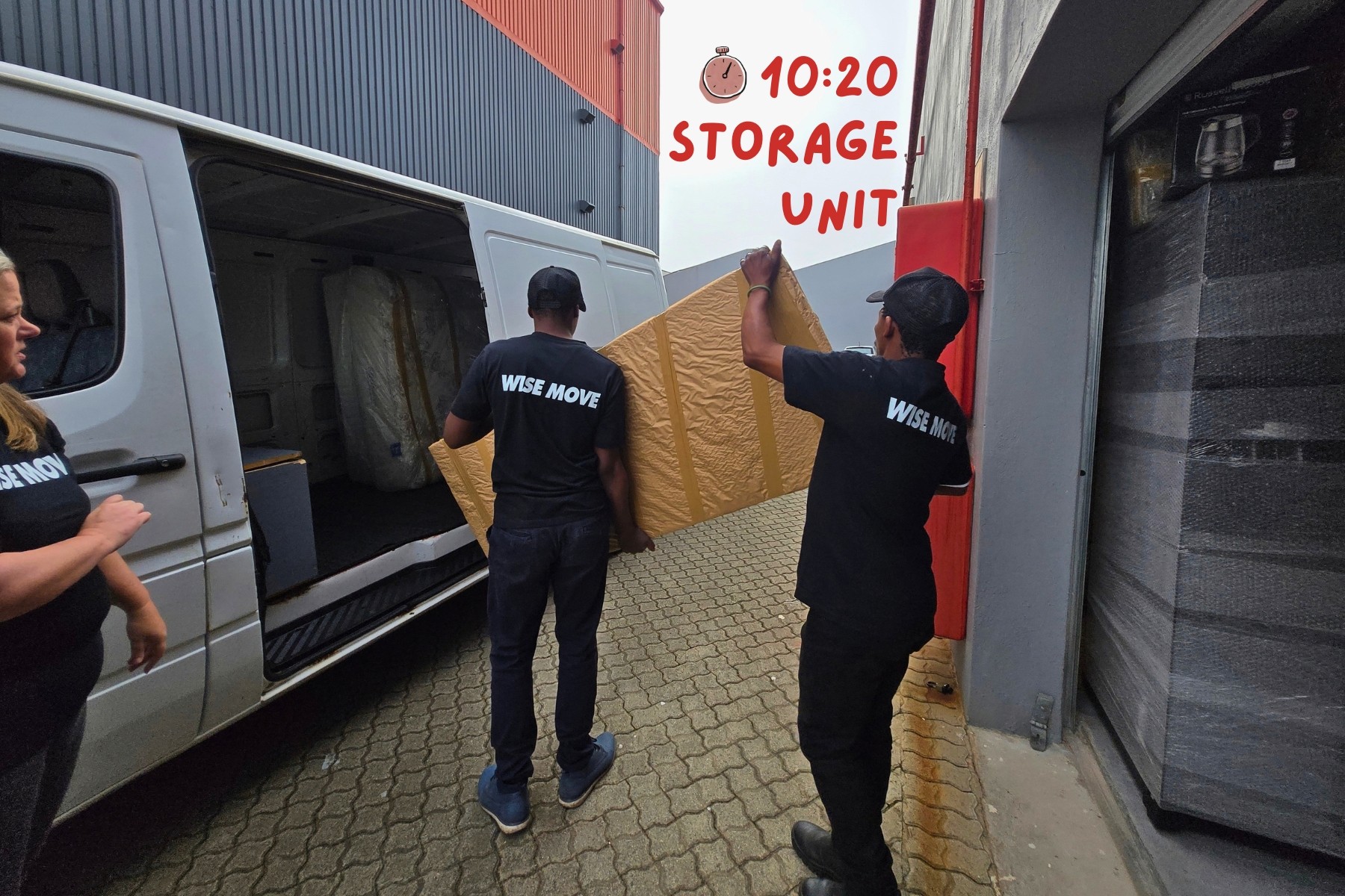 Wise Move movers loading mirror into truck at storage unit