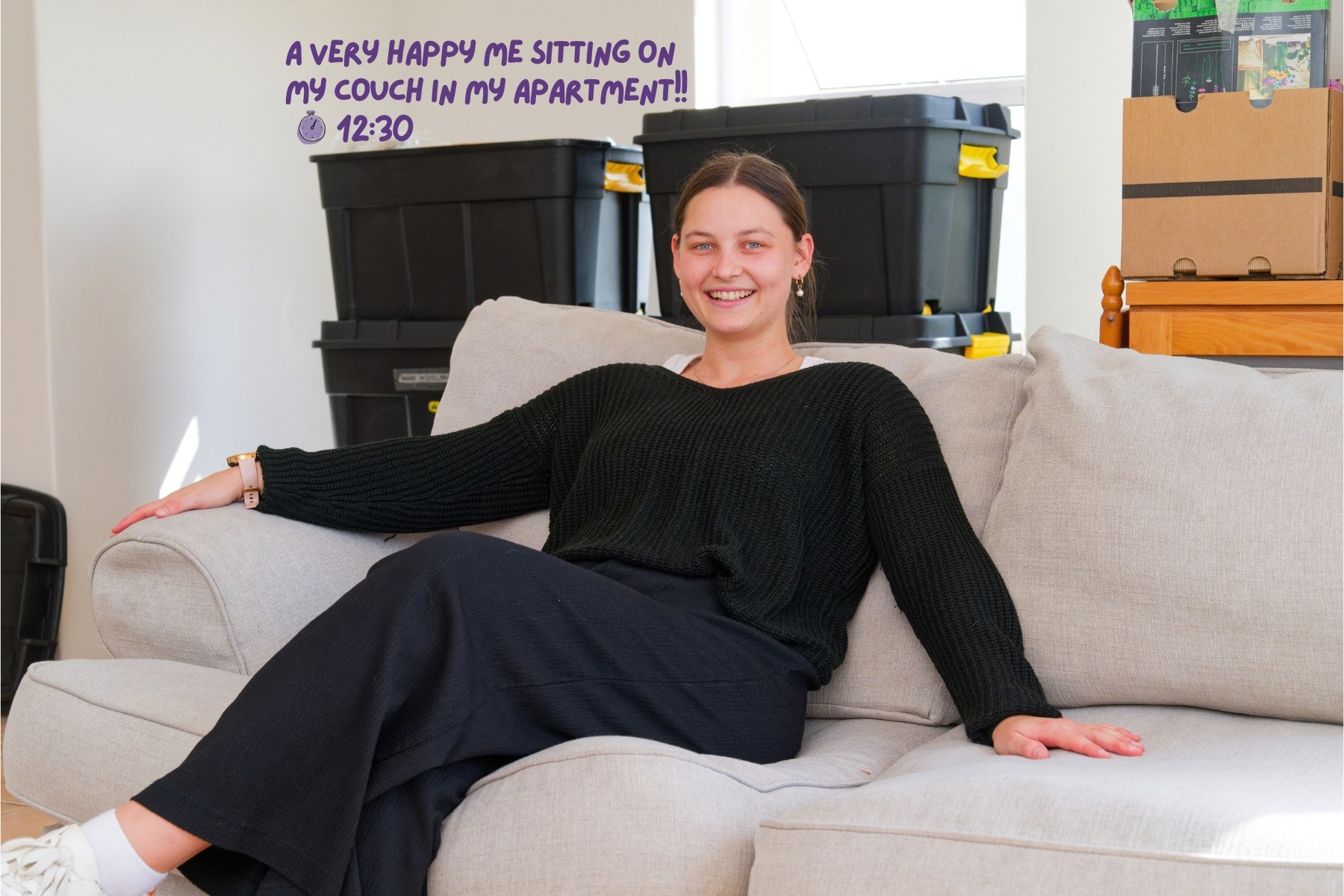 Woman sitting smiling on her couch in her new apartment after just moving