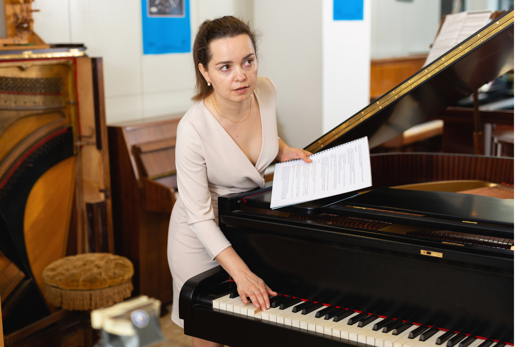 woman buying second-hand piano plays the keys