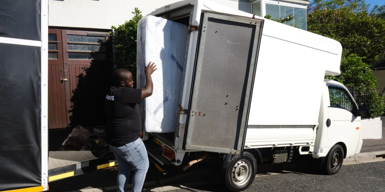 Two men carrying a drawer